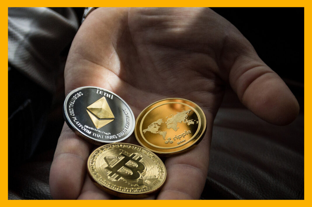Hand holding various cryptocurrency symbols, representing the diverse passive income opportunities in the crypto world.